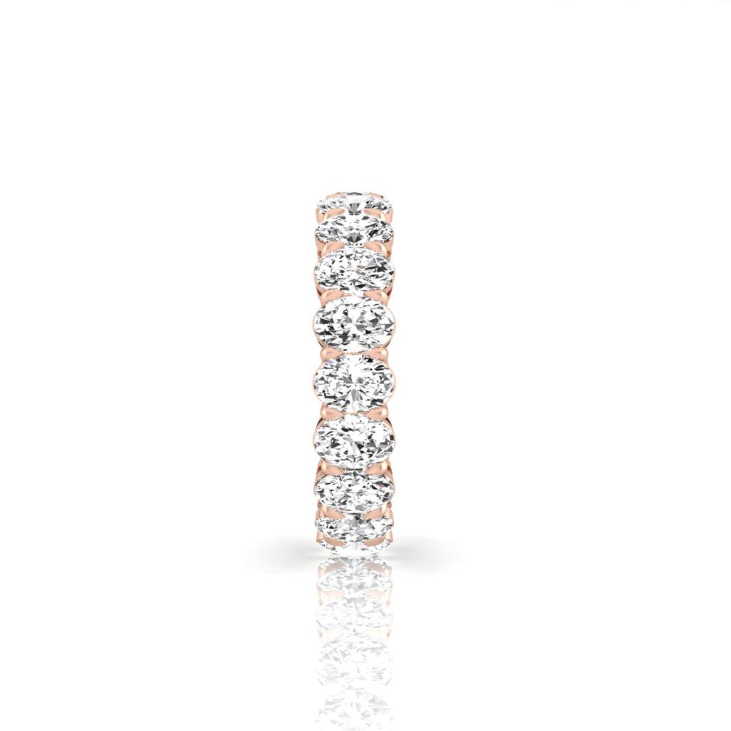 The Full Lab Grown Diamond Eternity Ring from Janet Heller Fine Jewelry, crafted in 18KT gold, features evenly spaced diamonds offered in various shapes and custom carat weights. The color of the diamonds is F and the clarity is VS. This is the perfect wedding band to be worn alone or stacked with your engagement ring.