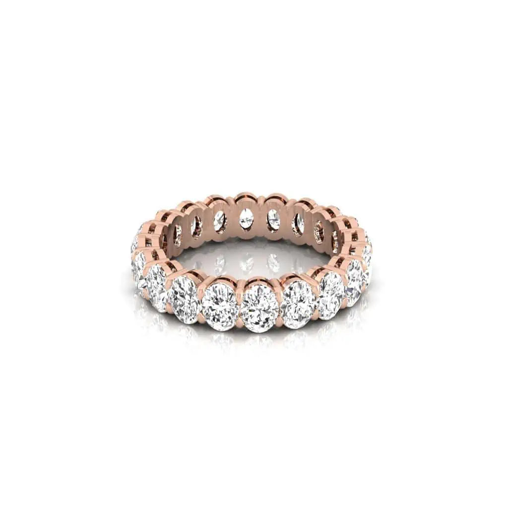 The Full Diamond Eternity Ring from Janet Heller Fine Jewelry, crafted in 18KT gold, features evenly spaced diamonds offered in various shapes and custom carat weights. The color of the diamonds is F and the clarity is VS. This is the perfect wedding band to be worn alone or stacked with your engagement ring.