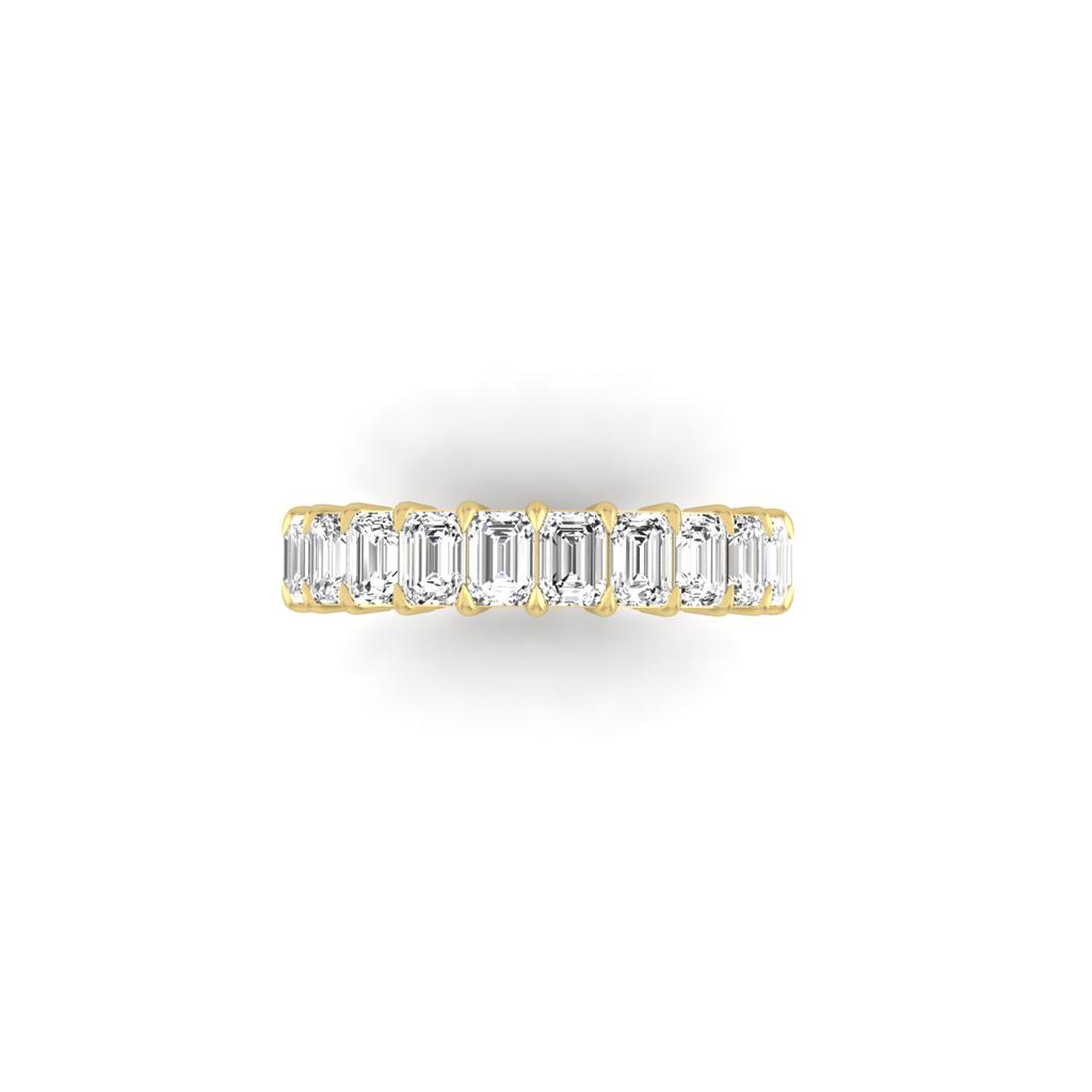 The Full Lab Grown Diamond Eternity Ring from Janet Heller Fine Jewelry, crafted in 18KT gold, features evenly spaced diamonds offered in various shapes and custom carat weights. The color of the diamonds is F and the clarity is VS. This is the perfect wedding band to be worn alone or stacked with your engagement ring.