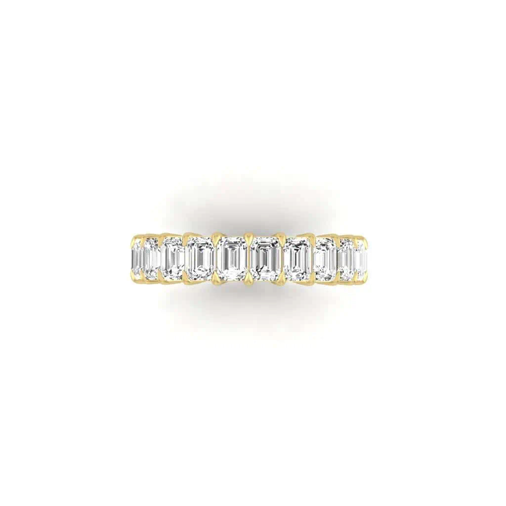 The Full Diamond Eternity Ring from Janet Heller Fine Jewelry, crafted in 18KT gold, features evenly spaced diamonds offered in various shapes and custom carat weights. The color of the diamonds is F and the clarity is VS. This is the perfect wedding band to be worn alone or stacked with your engagement ring.