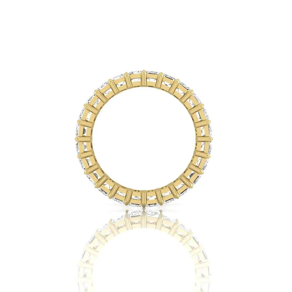 The Full Diamond Eternity Ring from Janet Heller Fine Jewelry, crafted in 18KT gold, features evenly spaced diamonds offered in various shapes and custom carat weights. The color of the diamonds is F and the clarity is VS. This is the perfect wedding band to be worn alone or stacked with your engagement ring.
