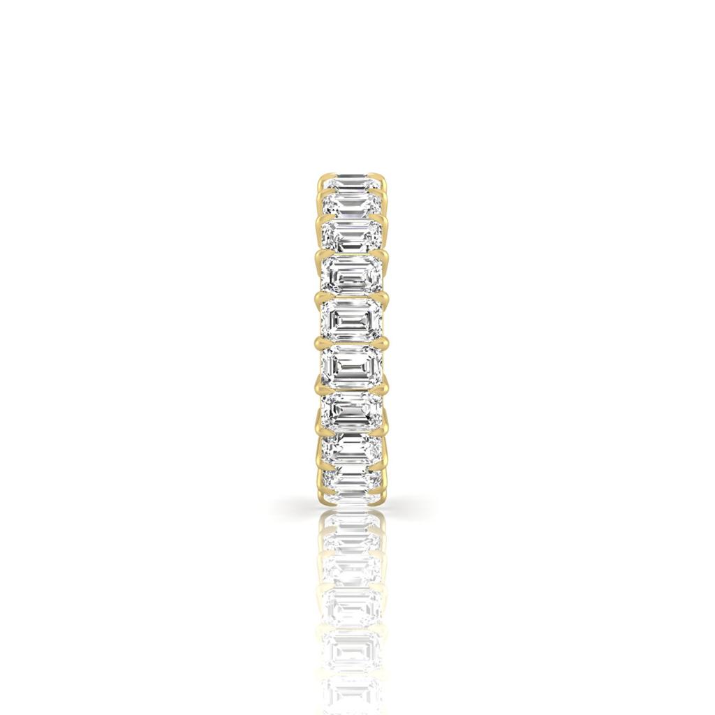 The Full Lab Grown Diamond Eternity Ring from Janet Heller Fine Jewelry, crafted in 18KT gold, features evenly spaced diamonds offered in various shapes and custom carat weights. The color of the diamonds is F and the clarity is VS. This is the perfect wedding band to be worn alone or stacked with your engagement ring.
