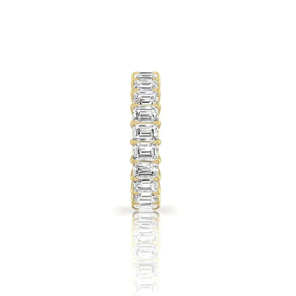 The Full Diamond Eternity Ring from Janet Heller Fine Jewelry, crafted in 18KT gold, features evenly spaced diamonds offered in various shapes and custom carat weights. The color of the diamonds is F and the clarity is VS. This is the perfect wedding band to be worn alone or stacked with your engagement ring.