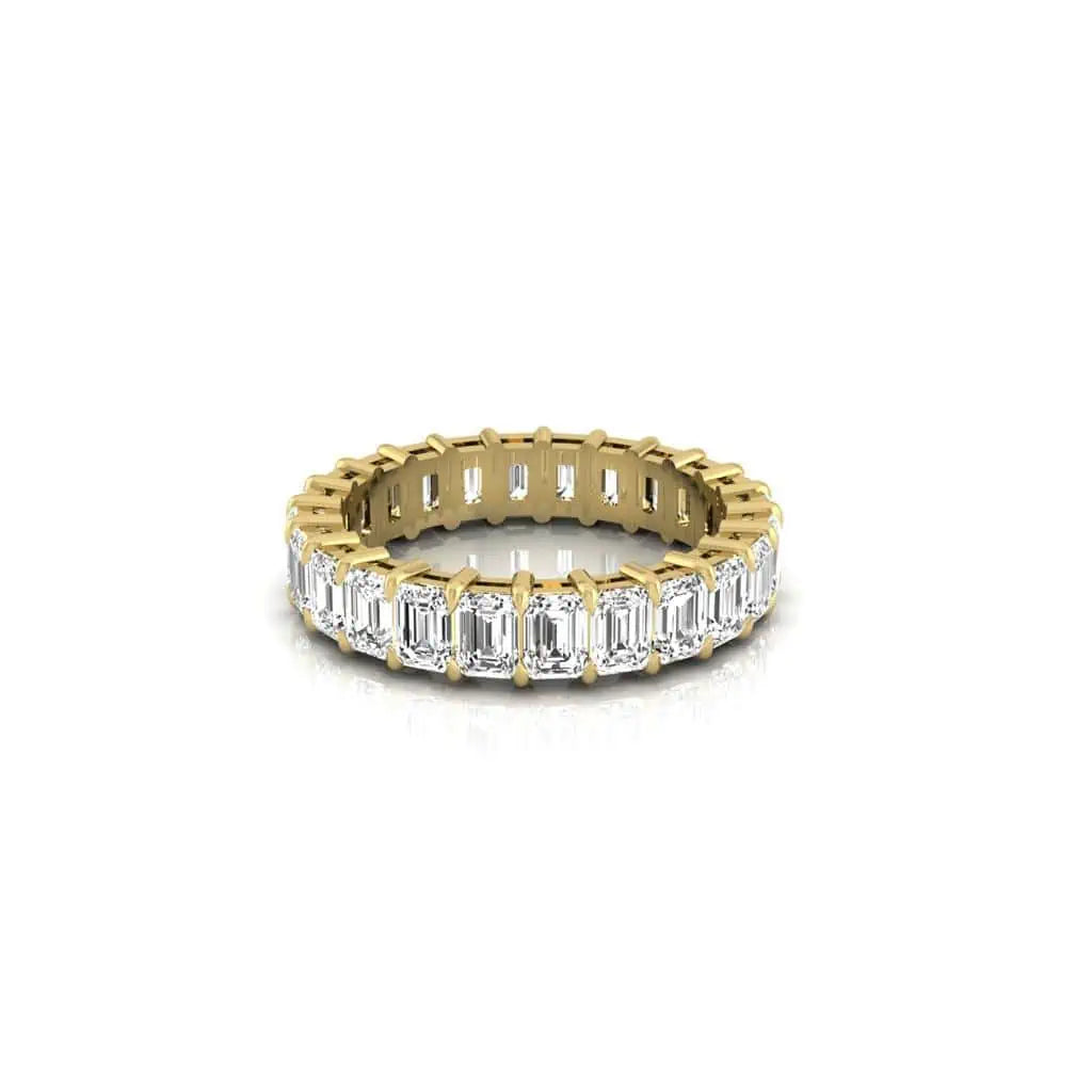 The Full Diamond Eternity Ring from Janet Heller Fine Jewelry, crafted in 18KT gold, features evenly spaced diamonds offered in various shapes and custom carat weights. The color of the diamonds is F and the clarity is VS. This is the perfect wedding band to be worn alone or stacked with your engagement ring.