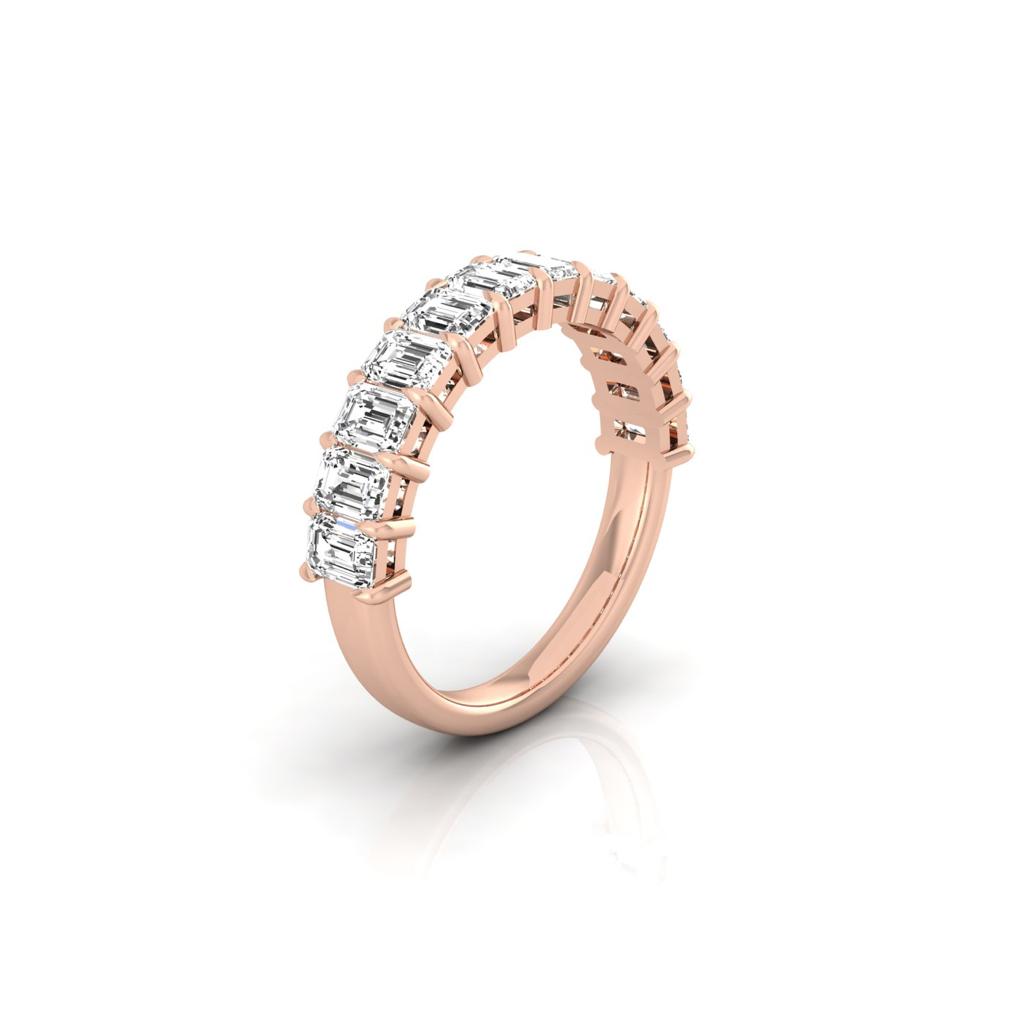 The Half Lab Grown Diamond Eternity Ring from Janet Heller Fine Jewelry, crafted in 18KT gold, features a row of evenly spaced diamonds offered in various shapes and custom carat weights. The color of the diamonds is F and the clarity is VS. This is the perfect wedding band to be worn alone or stacked with your engagement ring.