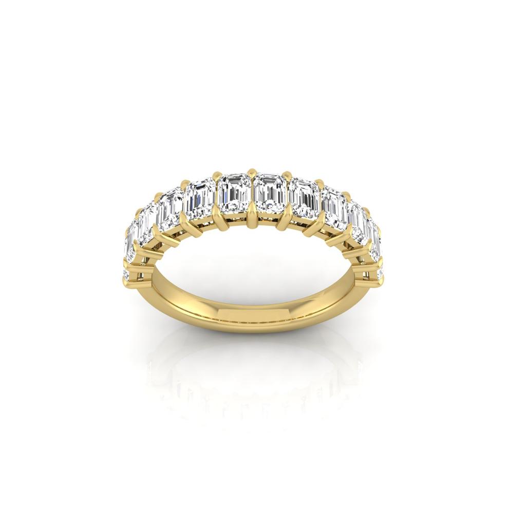 The Half Lab Grown Diamond Eternity Ring from Janet Heller Fine Jewelry, crafted in 18KT gold, features a row of evenly spaced diamonds offered in various shapes and custom carat weights. The color of the diamonds is F and the clarity is VS. This is the perfect wedding band to be worn alone or stacked with your engagement ring.