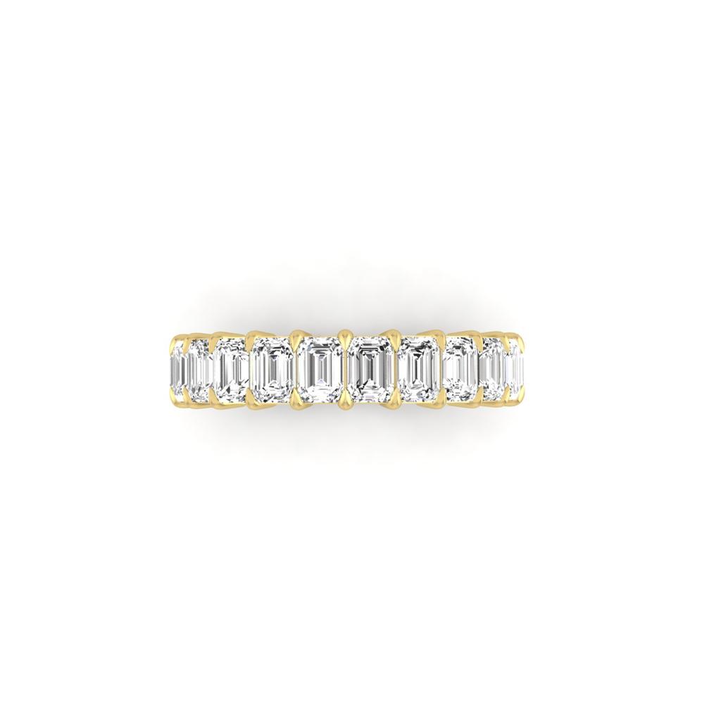 The Half Lab Grown Diamond Eternity Ring from Janet Heller Fine Jewelry, crafted in 18KT gold, features a row of evenly spaced diamonds offered in various shapes and custom carat weights. The color of the diamonds is F and the clarity is VS. This is the perfect wedding band to be worn alone or stacked with your engagement ring.