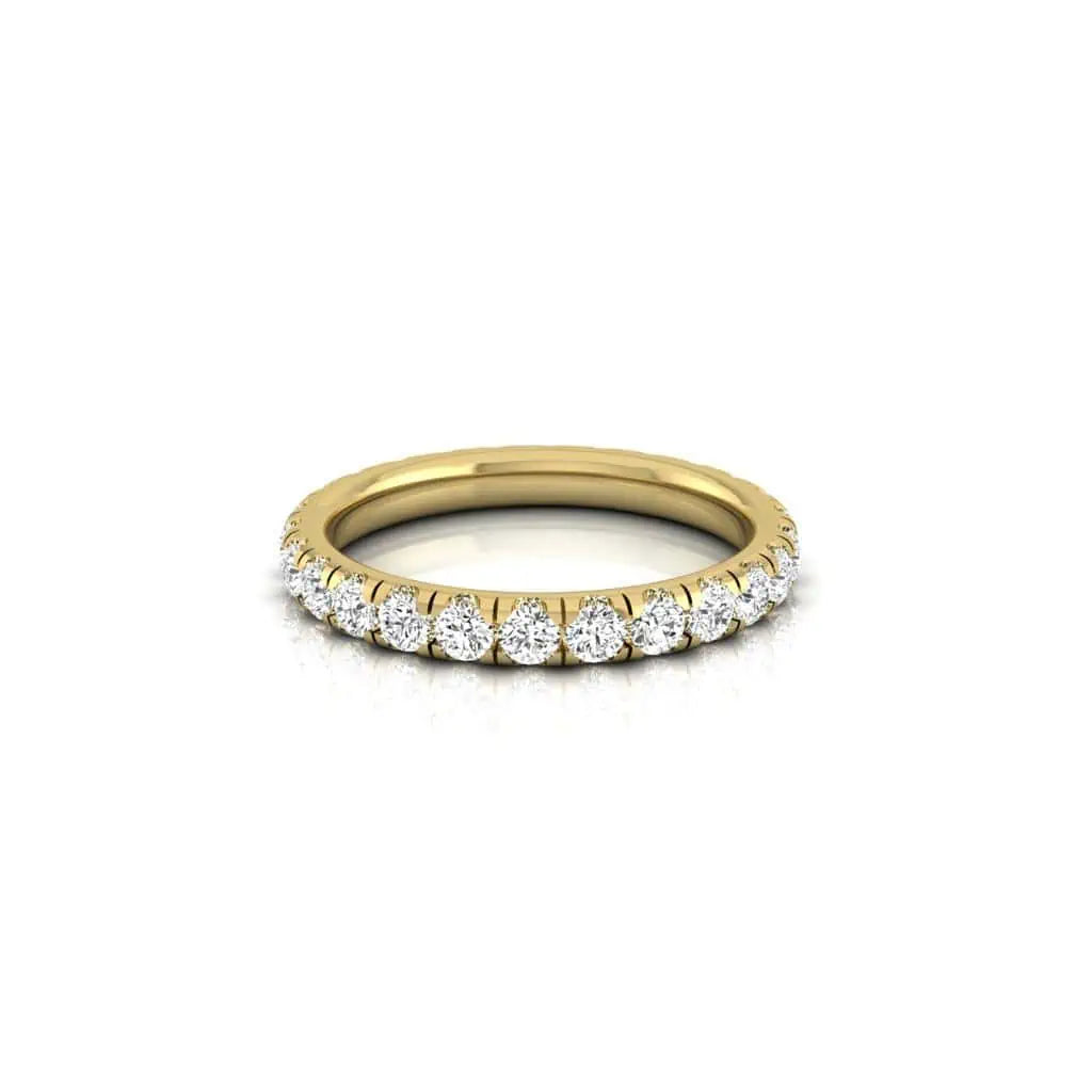 The 1ct Round Diamond Eternity Ring features a band of small, round sparkling VS clarity diamonds along the top half, set in 18KT gold. Its elegantly showcased on a reflective white surface to highlight its shine and elegance.