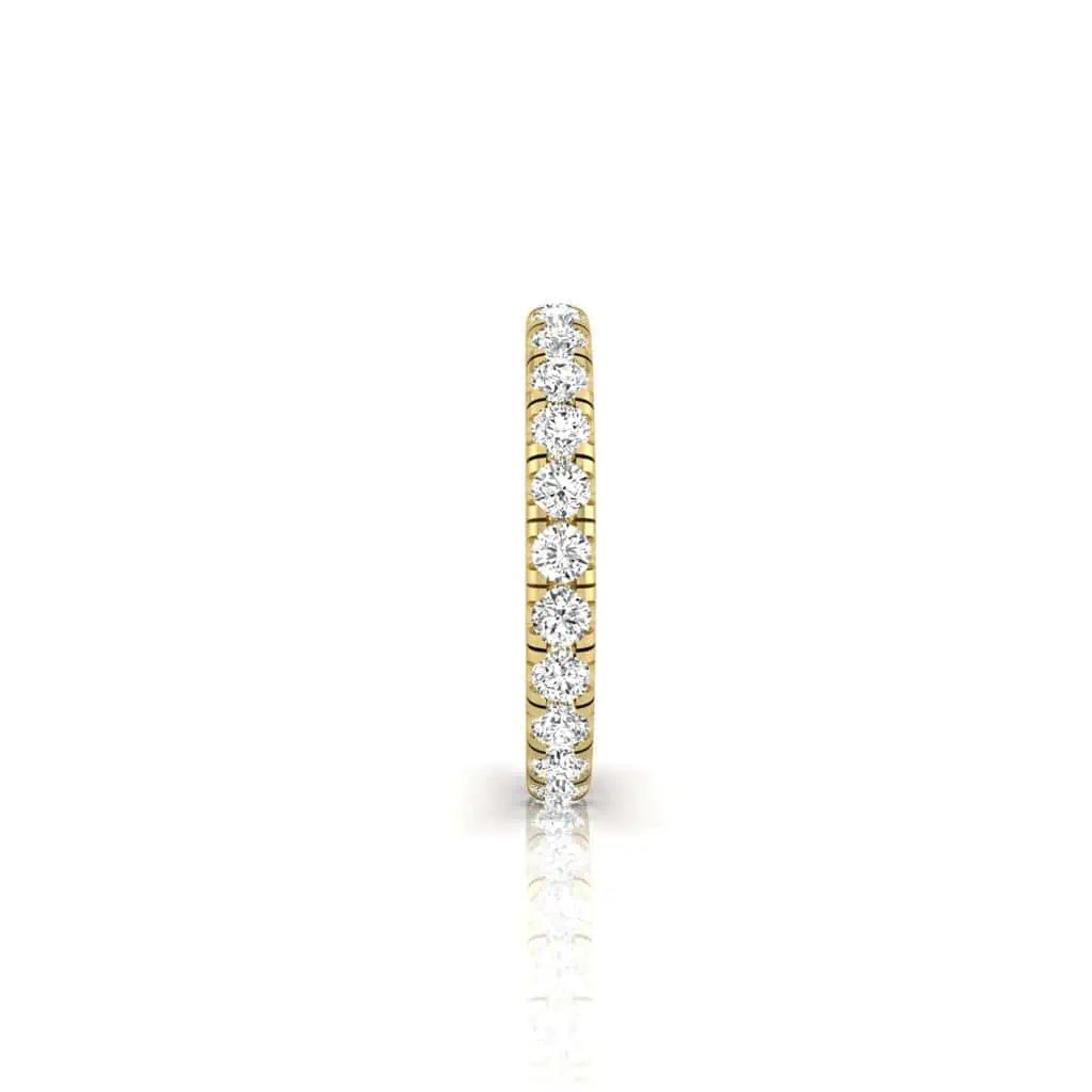 The 1ct Round Diamond Eternity Ring features an elegant, thin 18KT gold band adorned with a continuous row of round VS clarity diamonds on a white background.