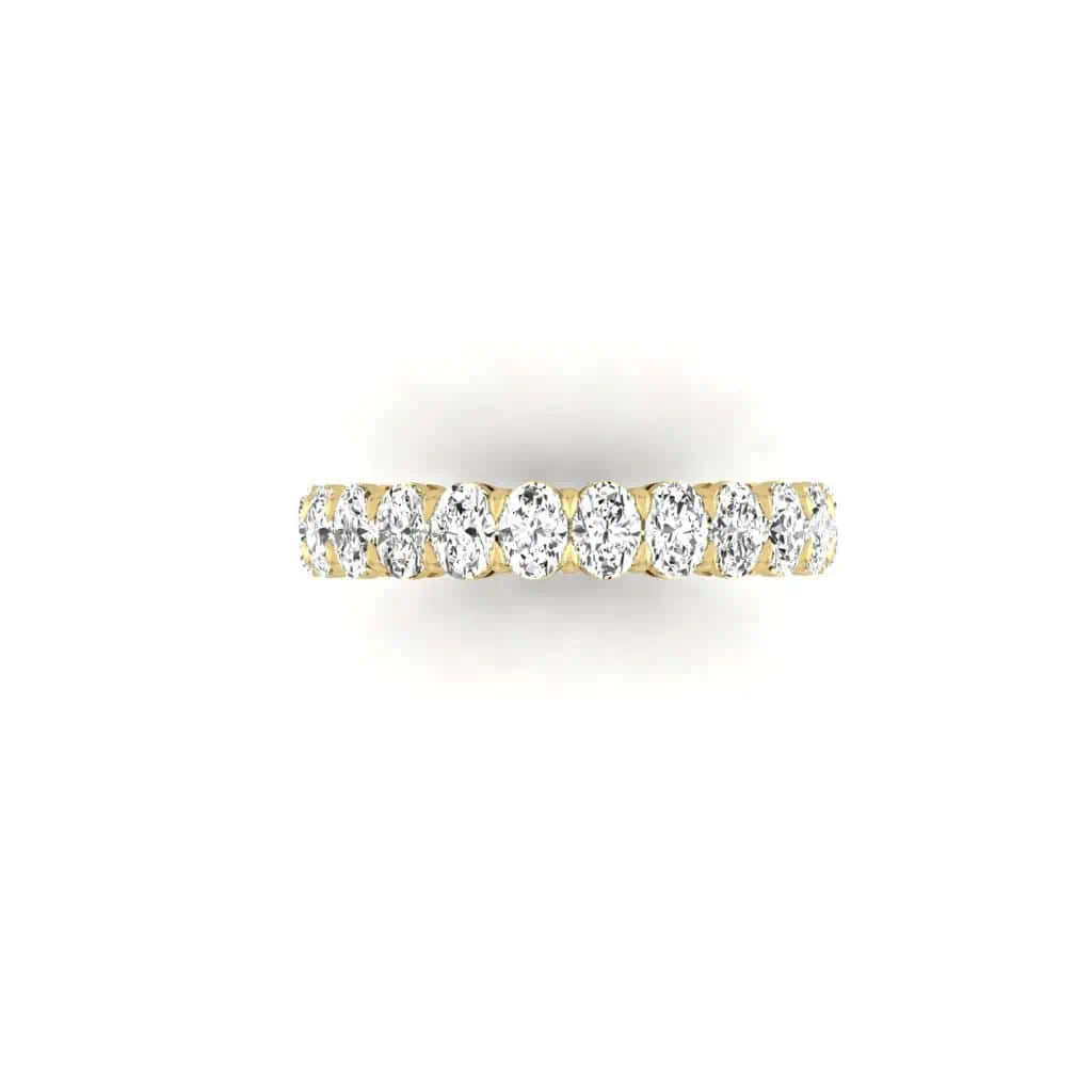 The Full Diamond Eternity Ring from Janet Heller Fine Jewelry, crafted in 18KT gold, features evenly spaced diamonds offered in various shapes and custom carat weights. The color of the diamonds is F and the clarity is VS. This is the perfect wedding band to be worn alone or stacked with your engagement ring.