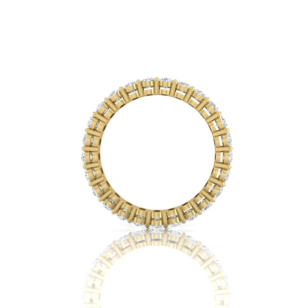 The Full Lab Grown Diamond Eternity Ring from Janet Heller Fine Jewelry, crafted in 18KT gold, features evenly spaced diamonds offered in various shapes and custom carat weights. The color of the diamonds is F and the clarity is VS. This is the perfect wedding band to be worn alone or stacked with your engagement ring.