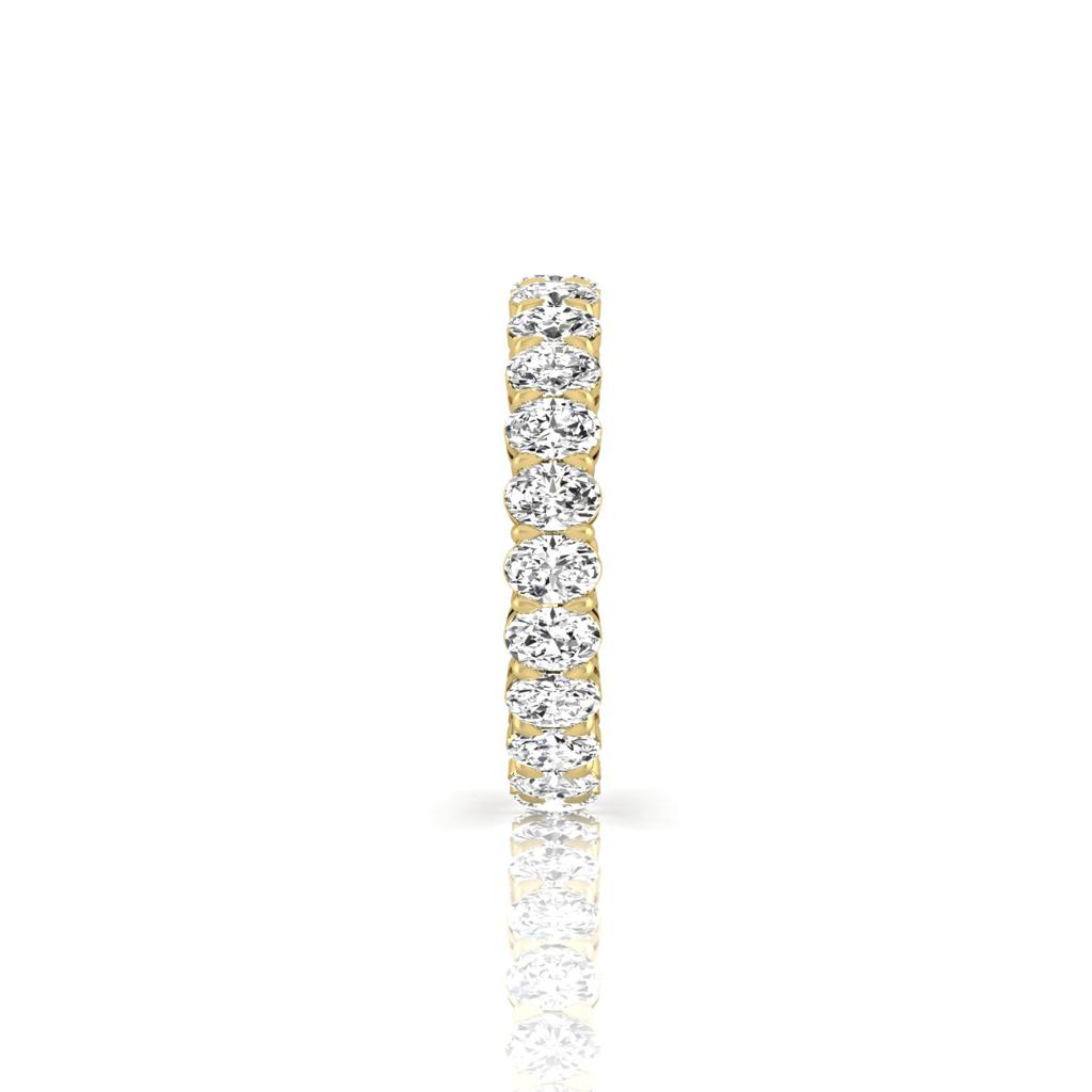 The Full Lab Grown Diamond Eternity Ring from Janet Heller Fine Jewelry, crafted in 18KT gold, features evenly spaced diamonds offered in various shapes and custom carat weights. The color of the diamonds is F and the clarity is VS. This is the perfect wedding band to be worn alone or stacked with your engagement ring.