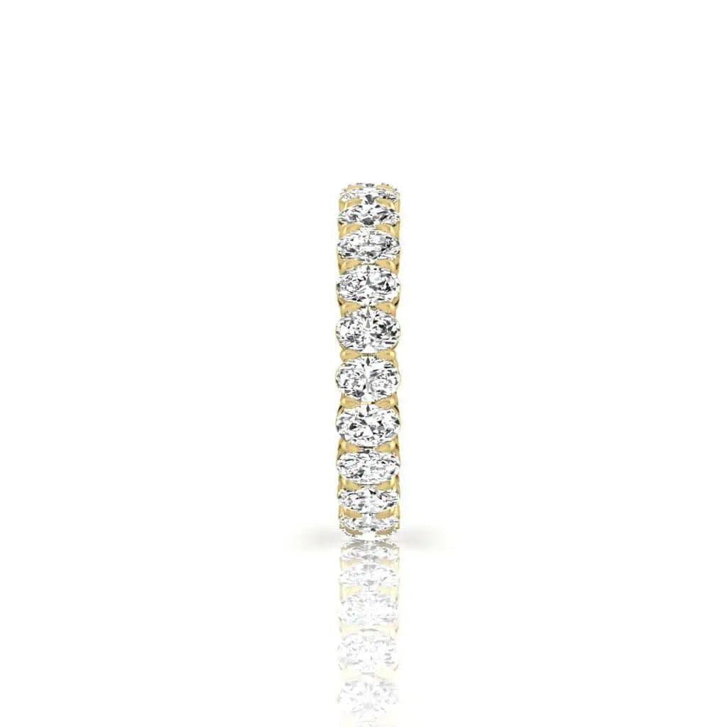 The Full Diamond Eternity Ring from Janet Heller Fine Jewelry, crafted in 18KT gold, features evenly spaced diamonds offered in various shapes and custom carat weights. The color of the diamonds is F and the clarity is VS. This is the perfect wedding band to be worn alone or stacked with your engagement ring.