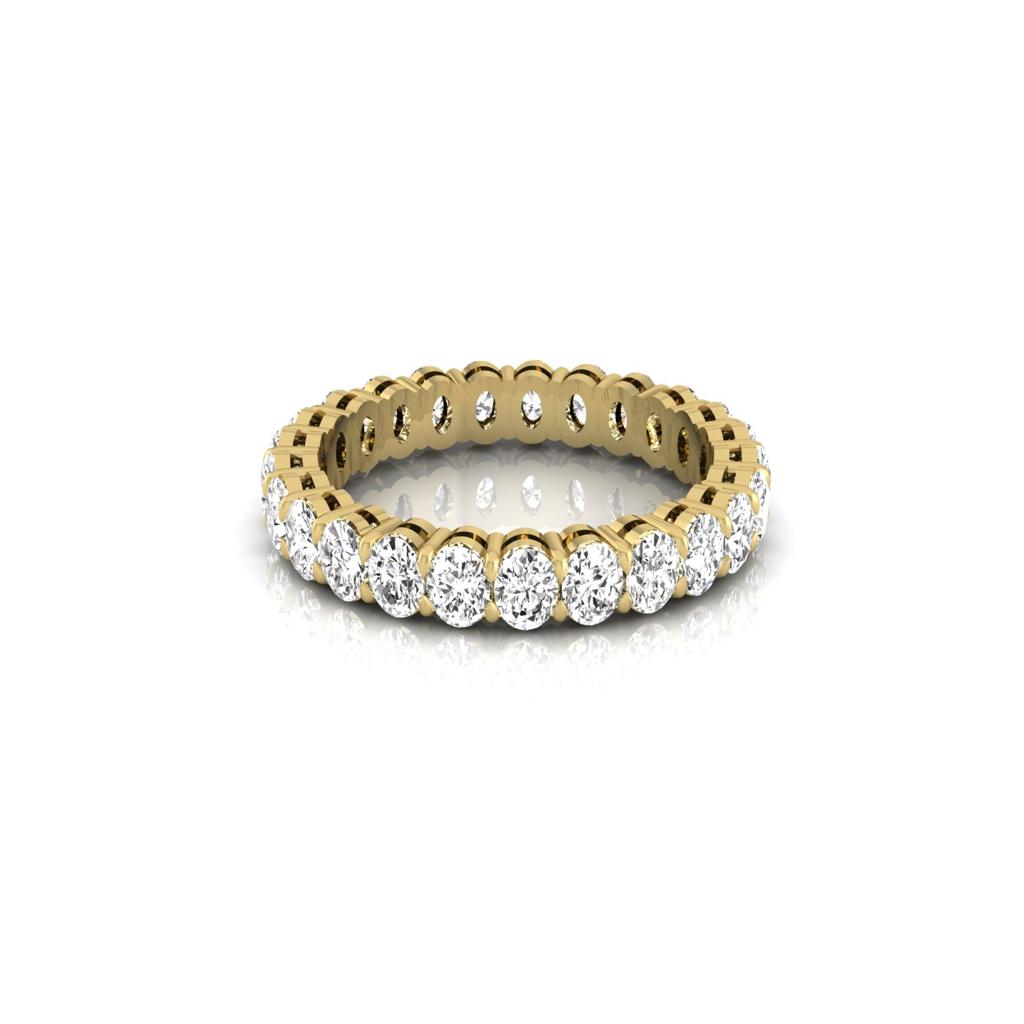 The Full Lab Grown Diamond Eternity Ring from Janet Heller Fine Jewelry, crafted in 18KT gold, features evenly spaced diamonds offered in various shapes and custom carat weights. The color of the diamonds is F and the clarity is VS. This is the perfect wedding band to be worn alone or stacked with your engagement ring.