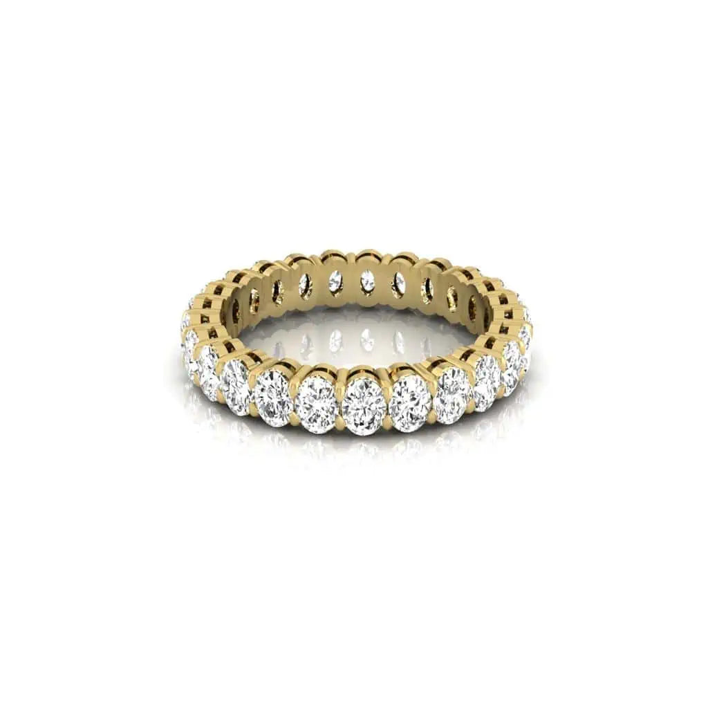The Full Diamond Eternity Ring from Janet Heller Fine Jewelry, crafted in 18KT gold, features evenly spaced diamonds offered in various shapes and custom carat weights. The color of the diamonds is F and the clarity is VS. This is the perfect wedding band to be worn alone or stacked with your engagement ring.