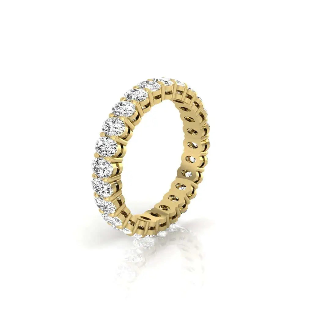 The Full Diamond Eternity Ring from Janet Heller Fine Jewelry, crafted in 18KT gold, features evenly spaced diamonds offered in various shapes and custom carat weights. The color of the diamonds is F and the clarity is VS. This is the perfect wedding band to be worn alone or stacked with your engagement ring.