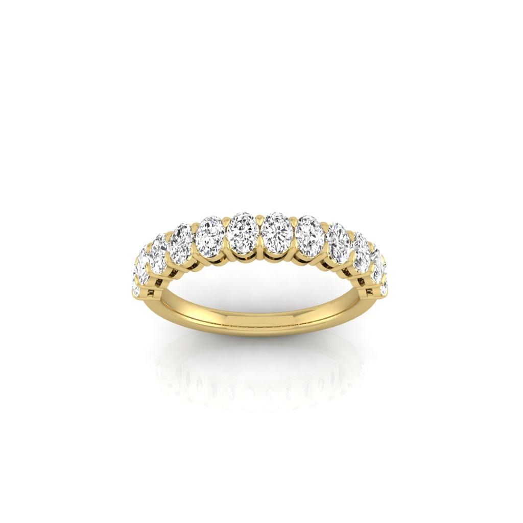 The Half Diamond Eternity Ring, crafted from 18KT Gold, showcases a row of VS Clarity round diamonds set along the band. Displayed on a plain white background, it highlights the rings elegant design and lustrous look.