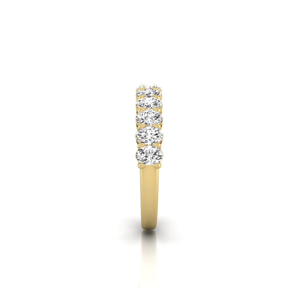 The Half Lab Grown Diamond Eternity Ring from Janet Heller Fine Jewelry, crafted in 18KT gold, features a row of evenly spaced diamonds offered in various shapes and custom carat weights. The color of the diamonds is F and the clarity is VS. This is the perfect wedding band to be worn alone or stacked with your engagement ring.
