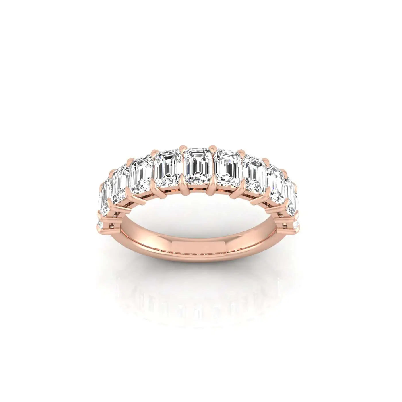 The Half Diamond Eternity Ring is a rose gold 18KT piece featuring a row of emerald-cut, VS clarity diamonds skillfully set along the band and displayed against a white background.
