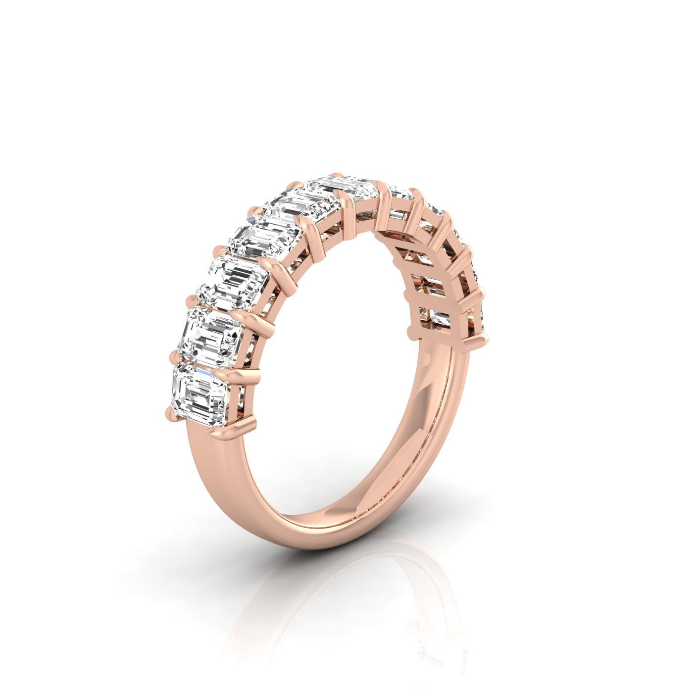 The Half Diamond Eternity Ring is crafted from exquisite 18KT rose gold and features a row of seven rectangular VS Clarity diamonds set along the band, showcased against a plain white background.