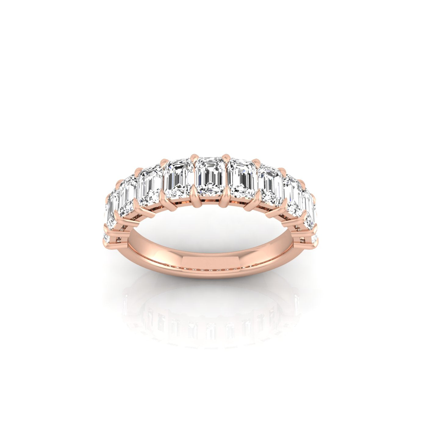 The Half Diamond Eternity Ring, made of 18KT rose gold and showcasing a row of emerald-cut VS clarity diamonds, is displayed against a white background, emphasizing its elegant design and brilliant gems.