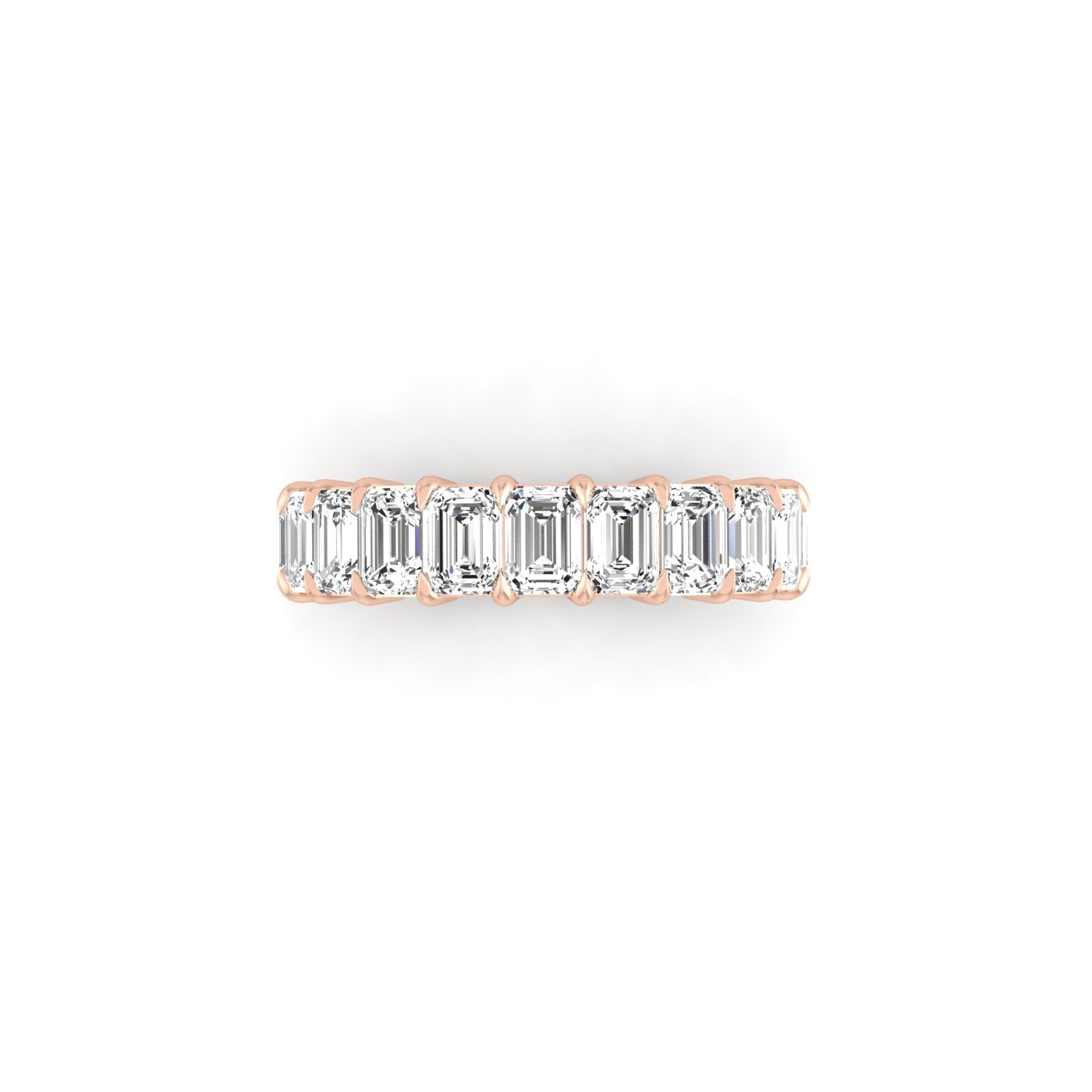 The Half Diamond Eternity Ring is an exquisite 18KT gold band adorned with rectangular-cut VS clarity diamonds, elegantly set and displayed on a white background.
