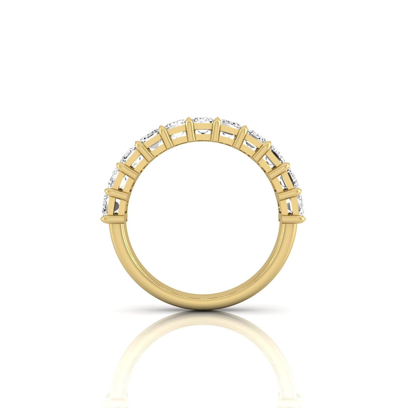 The Half Diamond Eternity Ring, crafted from 18KT gold, showcases a side view with VS clarity diamonds evenly spaced along the top half of the band, elegantly reflected on a white surface.