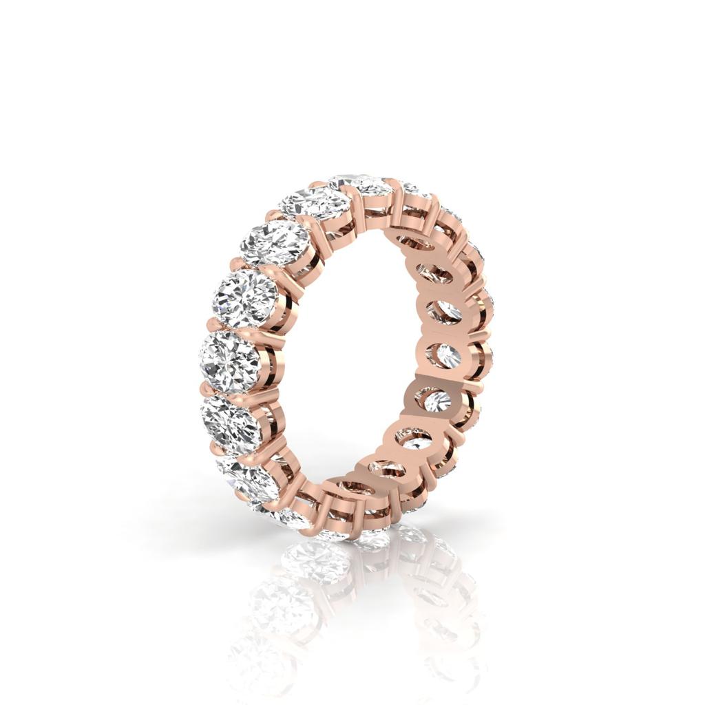 The Full Lab Grown Diamond Eternity Ring from Janet Heller Fine Jewelry, crafted in 18KT gold, features evenly spaced diamonds offered in various shapes and custom carat weights. The color of the diamonds is F and the clarity is VS. This is the perfect wedding band to be worn alone or stacked with your engagement ring.