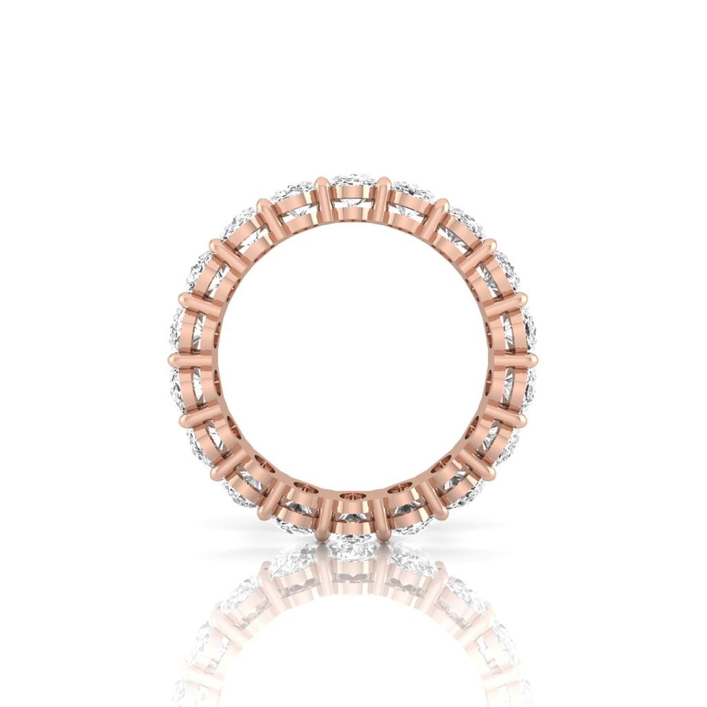 The Full Lab Grown Diamond Eternity Ring from Janet Heller Fine Jewelry, crafted in 18KT gold, features evenly spaced diamonds offered in various shapes and custom carat weights. The color of the diamonds is F and the clarity is VS. This is the perfect wedding band to be worn alone or stacked with your engagement ring.