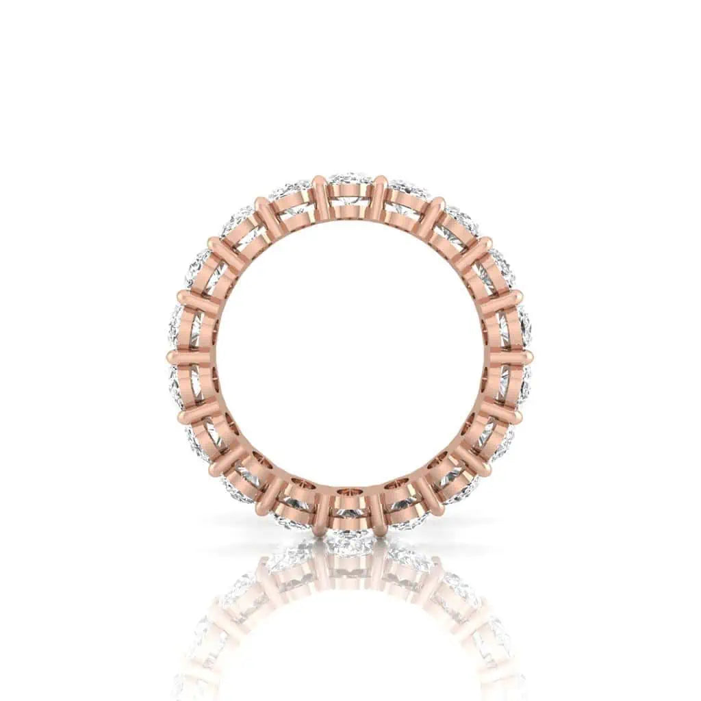 The Full Diamond Eternity Ring from Janet Heller Fine Jewelry, crafted in 18KT gold, features evenly spaced diamonds offered in various shapes and custom carat weights. The color of the diamonds is F and the clarity is VS. This is the perfect wedding band to be worn alone or stacked with your engagement ring.