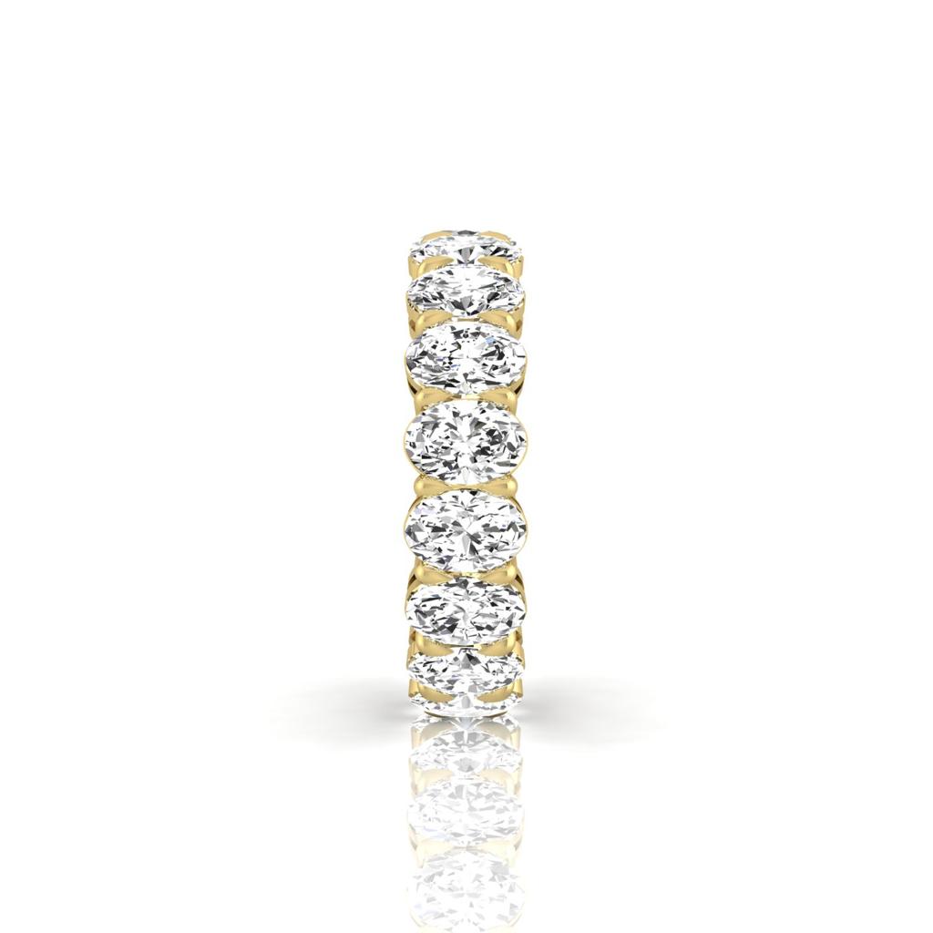 The Full Lab Grown Diamond Eternity Ring from Janet Heller Fine Jewelry, crafted in 18KT gold, features evenly spaced diamonds offered in various shapes and custom carat weights. The color of the diamonds is F and the clarity is VS. This is the perfect wedding band to be worn alone or stacked with your engagement ring.