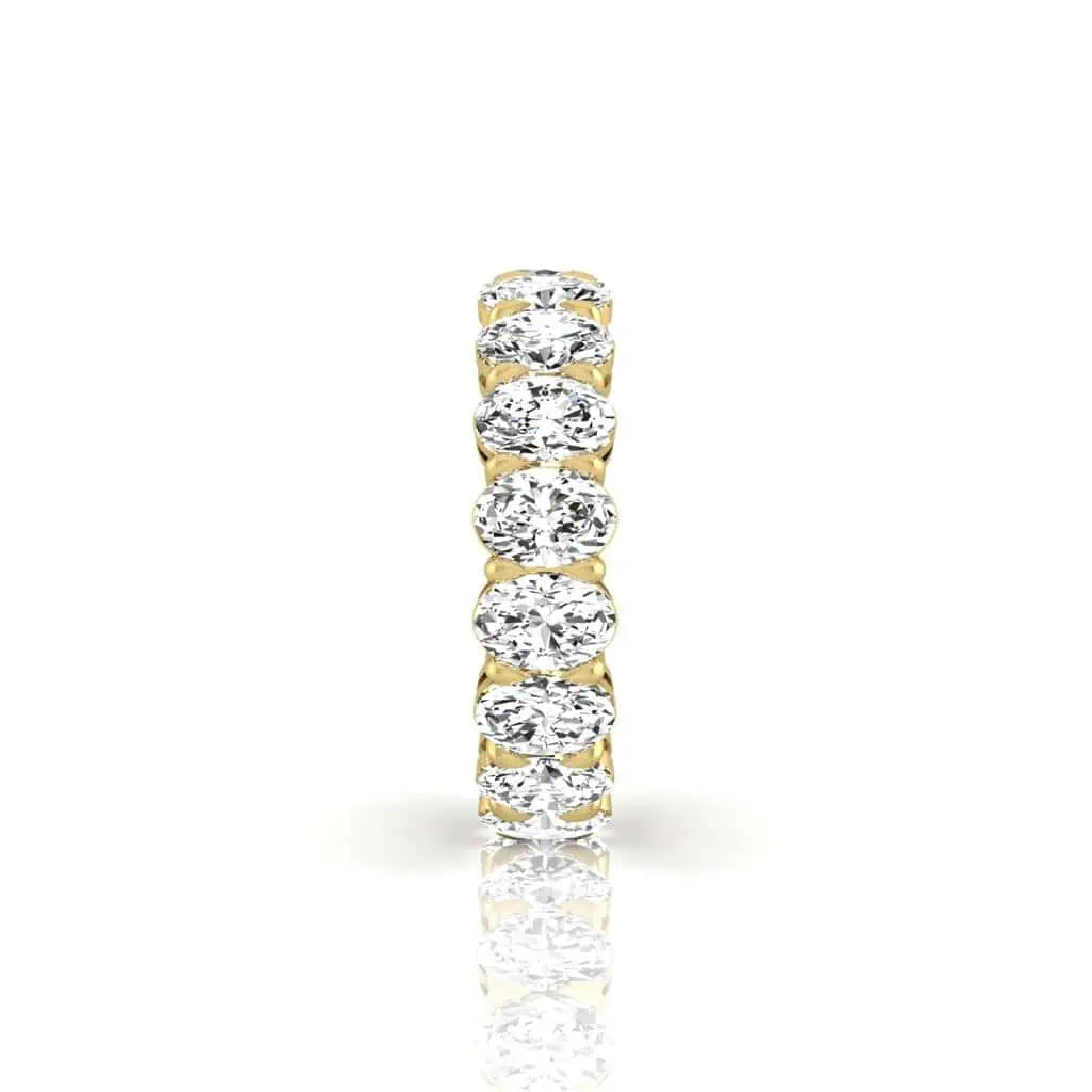 The Full Diamond Eternity Ring from Janet Heller Fine Jewelry, crafted in 18KT gold, features evenly spaced diamonds offered in various shapes and custom carat weights. The color of the diamonds is F and the clarity is VS. This is the perfect wedding band to be worn alone or stacked with your engagement ring.