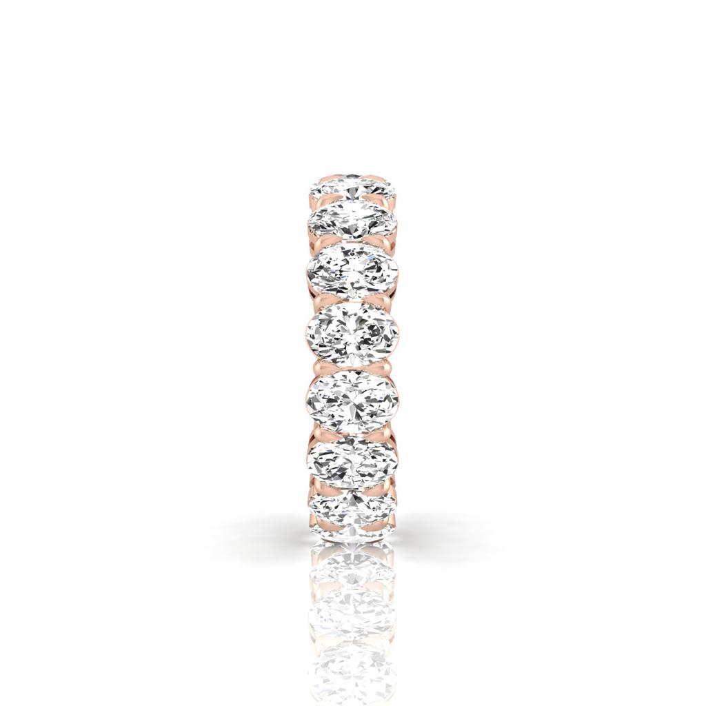 The Full Lab Grown Diamond Eternity Ring from Janet Heller Fine Jewelry, crafted in 18KT gold, features evenly spaced diamonds offered in various shapes and custom carat weights. The color of the diamonds is F and the clarity is VS. This is the perfect wedding band to be worn alone or stacked with your engagement ring.