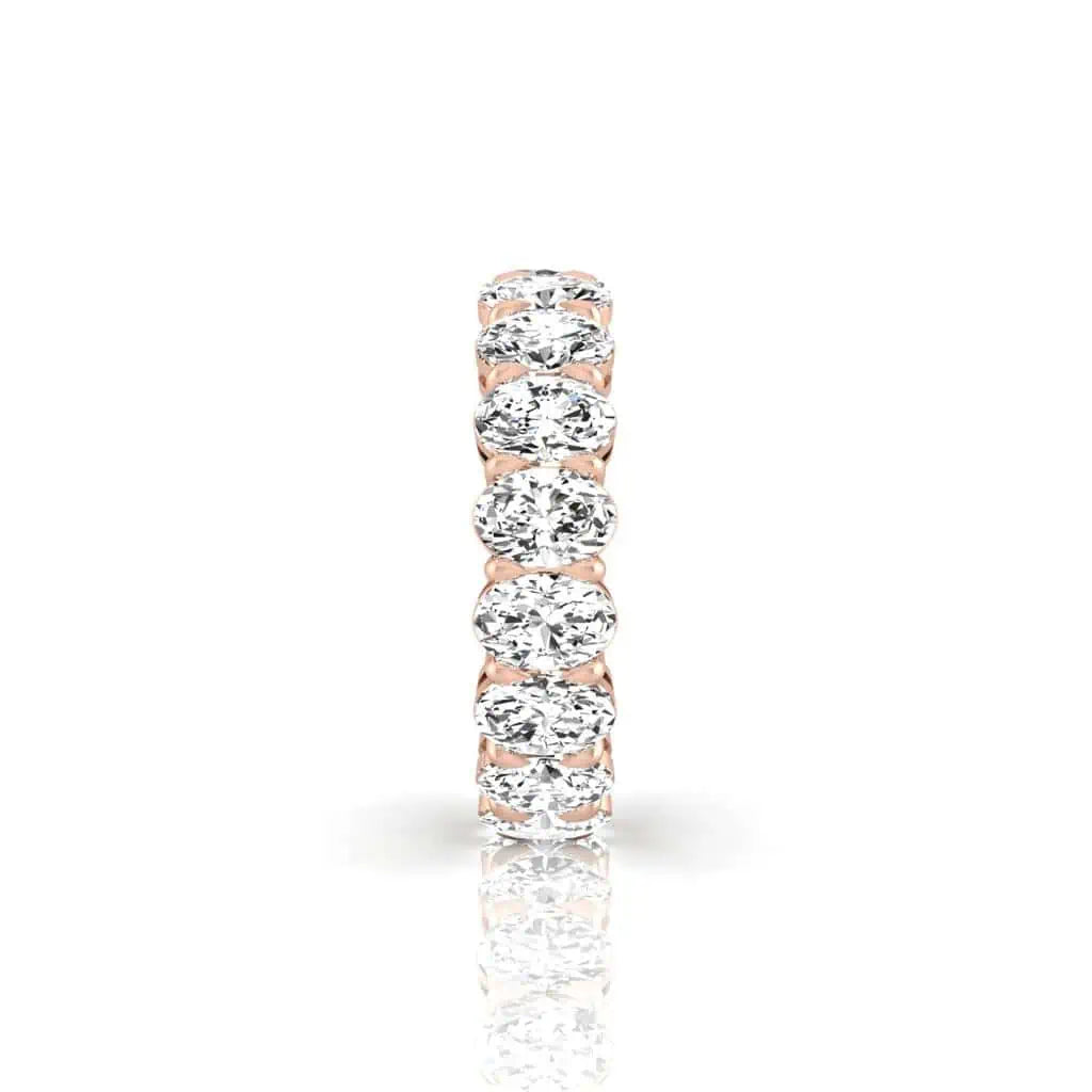 The Full Diamond Eternity Ring from Janet Heller Fine Jewelry, crafted in 18KT gold, features evenly spaced diamonds offered in various shapes and custom carat weights. The color of the diamonds is F and the clarity is VS. This is the perfect wedding band to be worn alone or stacked with your engagement ring.