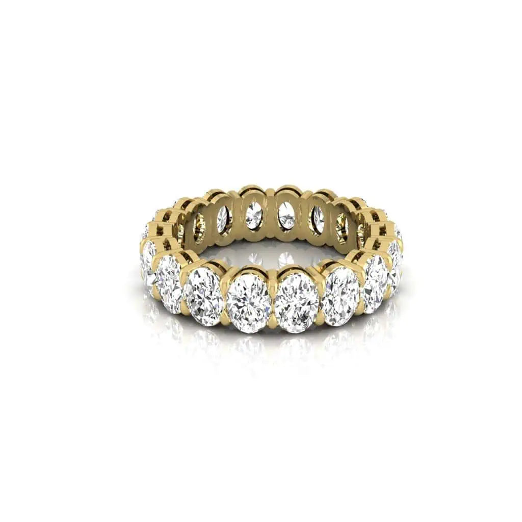 The Full Diamond Eternity Ring from Janet Heller Fine Jewelry, crafted in 18KT gold, features evenly spaced diamonds offered in various shapes and custom carat weights. The color of the diamonds is F and the clarity is VS. This is the perfect wedding band to be worn alone or stacked with your engagement ring.