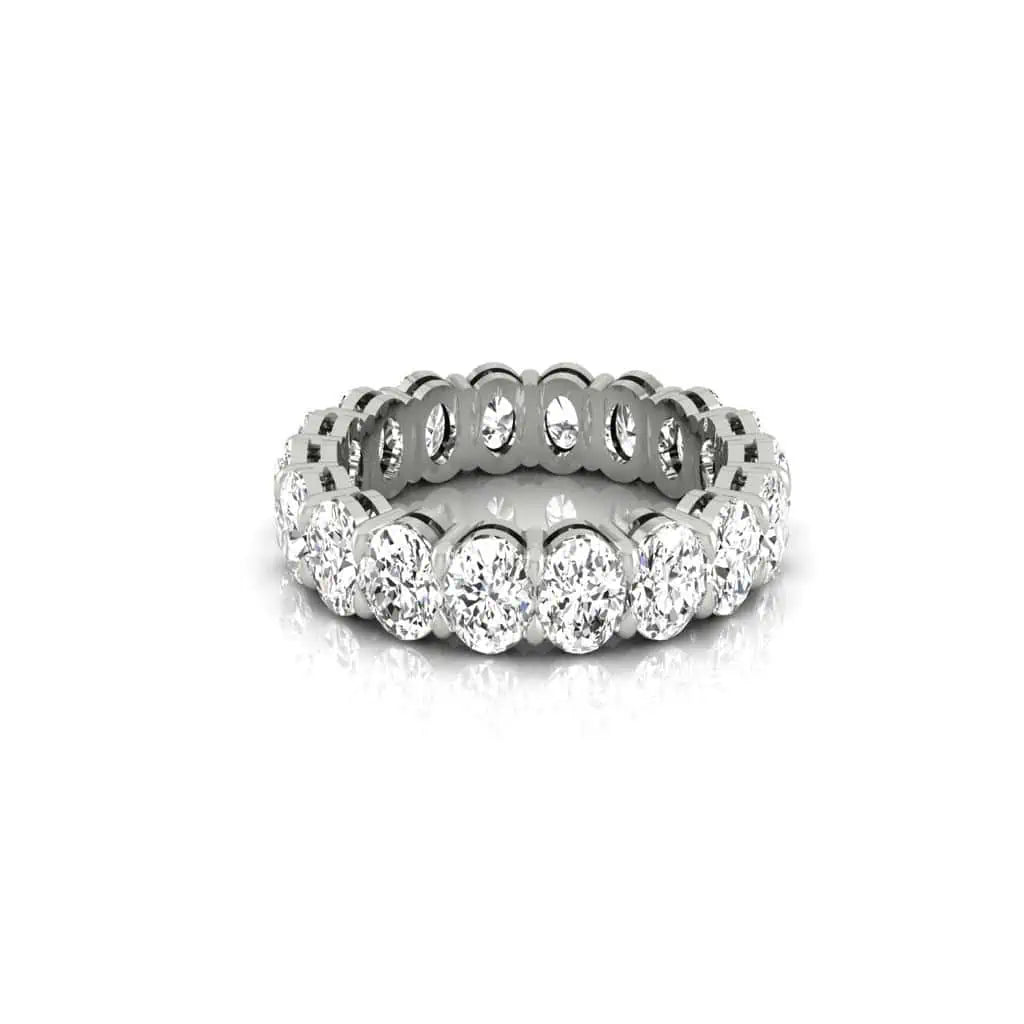 The Full Lab Grown Diamond Eternity Ring from Janet Heller Fine Jewelry, crafted in 18KT gold, features evenly spaced diamonds offered in various shapes and custom carat weights. The color of the diamonds is F and the clarity is VS. This is the perfect wedding band to be worn alone or stacked with your engagement ring.
