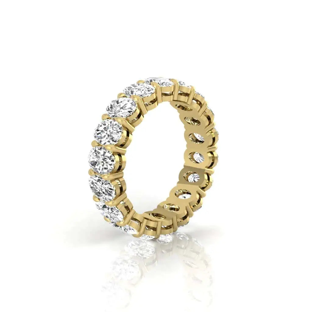 The Full Diamond Eternity Ring from Janet Heller Fine Jewelry, crafted in 18KT gold, features evenly spaced diamonds offered in various shapes and custom carat weights. The color of the diamonds is F and the clarity is VS. This is the perfect wedding band to be worn alone or stacked with your engagement ring.