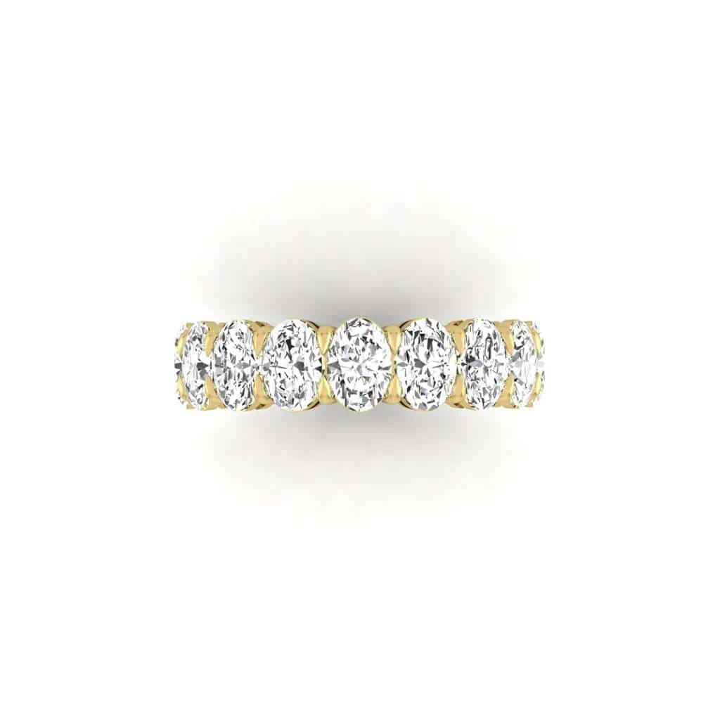 The Full Diamond Eternity Ring from Janet Heller Fine Jewelry, crafted in 18KT gold, features evenly spaced diamonds offered in various shapes and custom carat weights. The color of the diamonds is F and the clarity is VS. This is the perfect wedding band to be worn alone or stacked with your engagement ring.