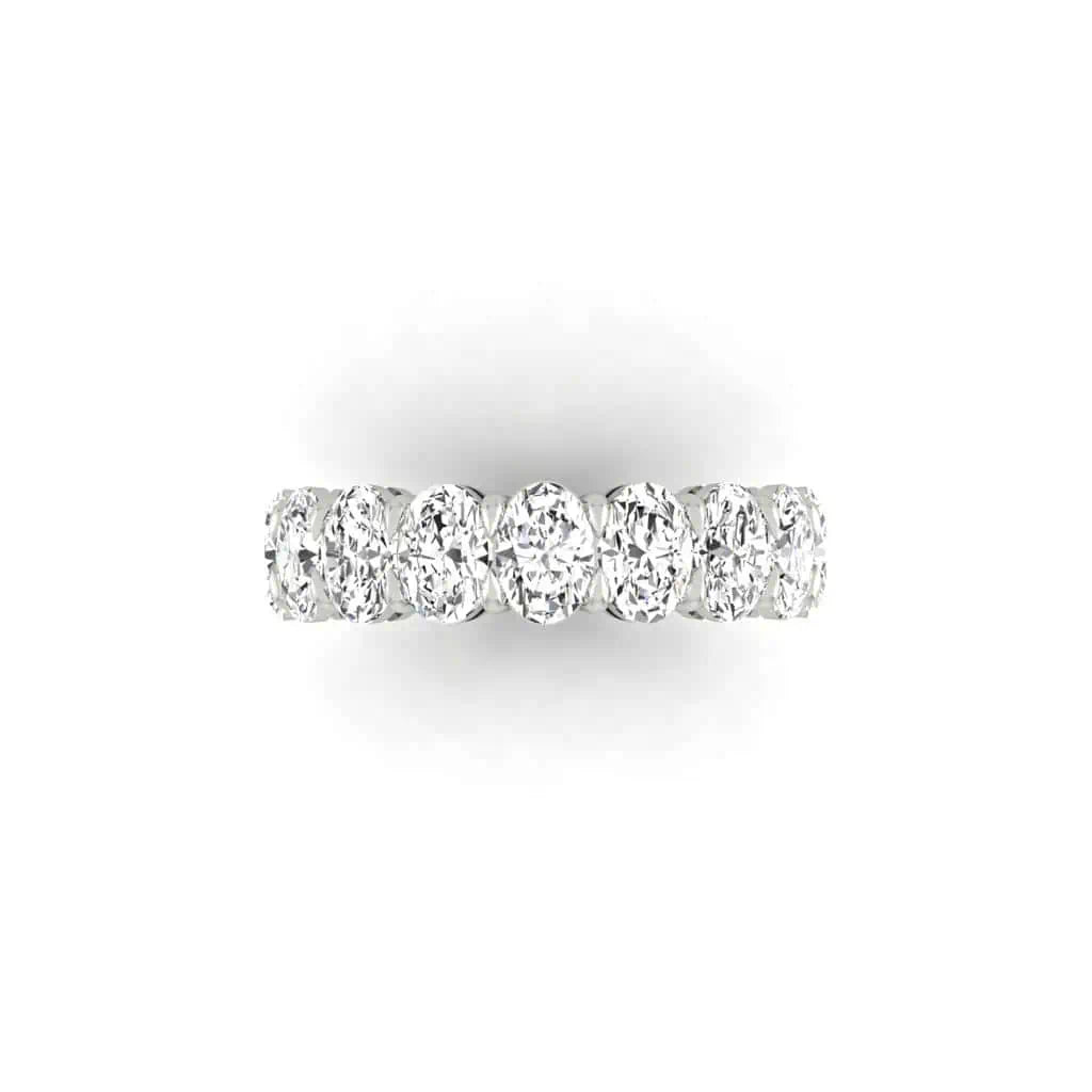 The Full Lab Grown Diamond Eternity Ring from Janet Heller Fine Jewelry, crafted in 18KT gold, features evenly spaced diamonds offered in various shapes and custom carat weights. The color of the diamonds is F and the clarity is VS. This is the perfect wedding band to be worn alone or stacked with your engagement ring.