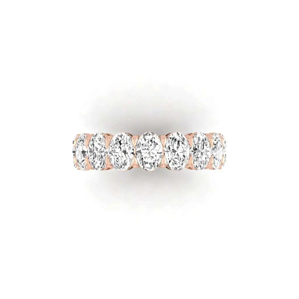 The Full Diamond Eternity Ring from Janet Heller Fine Jewelry, crafted in 18KT gold, features evenly spaced diamonds offered in various shapes and custom carat weights. The color of the diamonds is F and the clarity is VS. This is the perfect wedding band to be worn alone or stacked with your engagement ring.