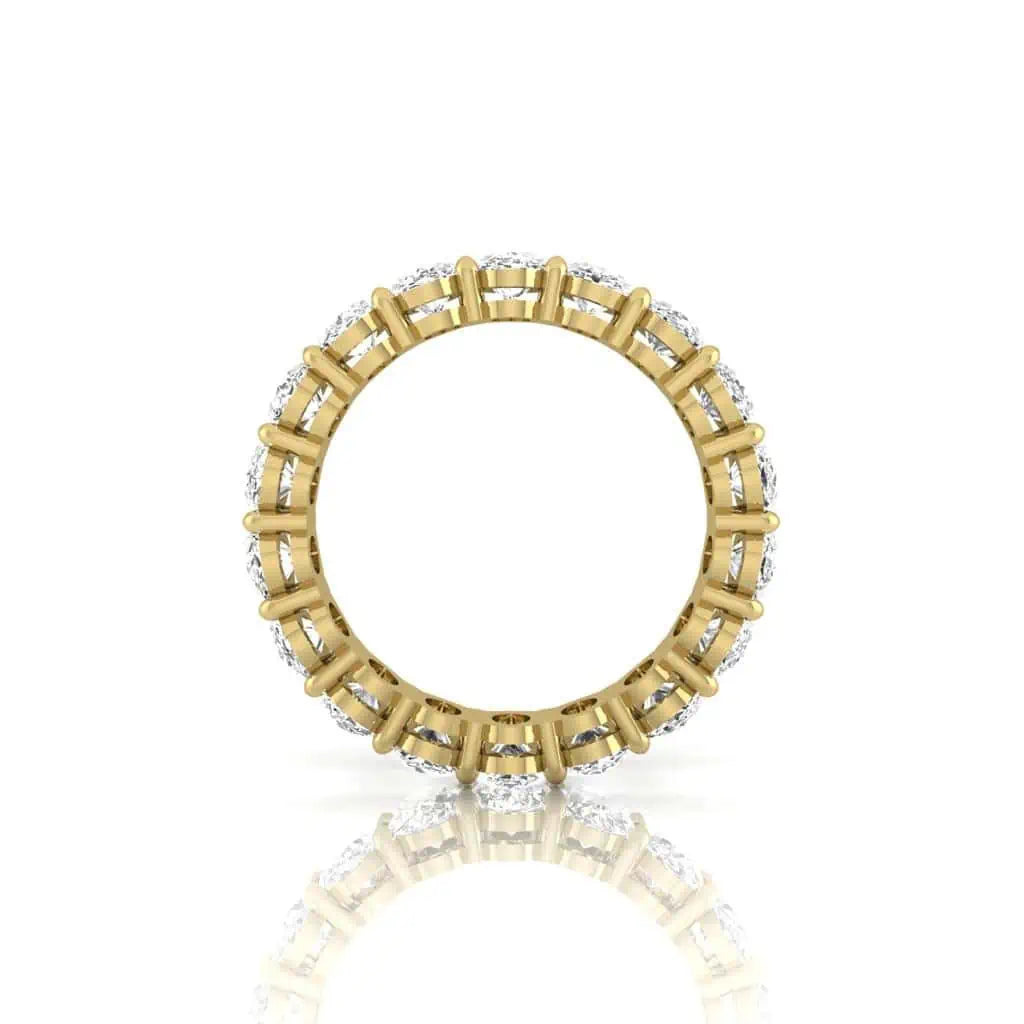 The Full Diamond Eternity Ring from Janet Heller Fine Jewelry, crafted in 18KT gold, features evenly spaced diamonds offered in various shapes and custom carat weights. The color of the diamonds is F and the clarity is VS. This is the perfect wedding band to be worn alone or stacked with your engagement ring.