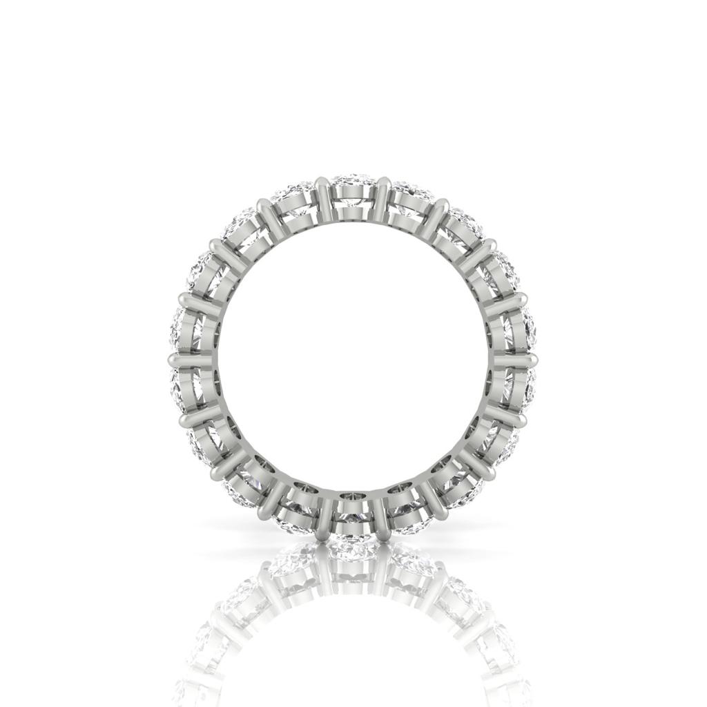 The Full Lab Grown Diamond Eternity Ring from Janet Heller Fine Jewelry, crafted in 18KT gold, features evenly spaced diamonds offered in various shapes and custom carat weights. The color of the diamonds is F and the clarity is VS. This is the perfect wedding band to be worn alone or stacked with your engagement ring.