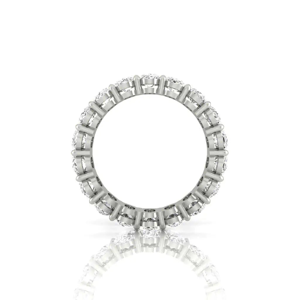 The Full Diamond Eternity Ring from Janet Heller Fine Jewelry, crafted in 18KT gold, features evenly spaced diamonds offered in various shapes and custom carat weights. The color of the diamonds is F and the clarity is VS. This is the perfect wedding band to be worn alone or stacked with your engagement ring.