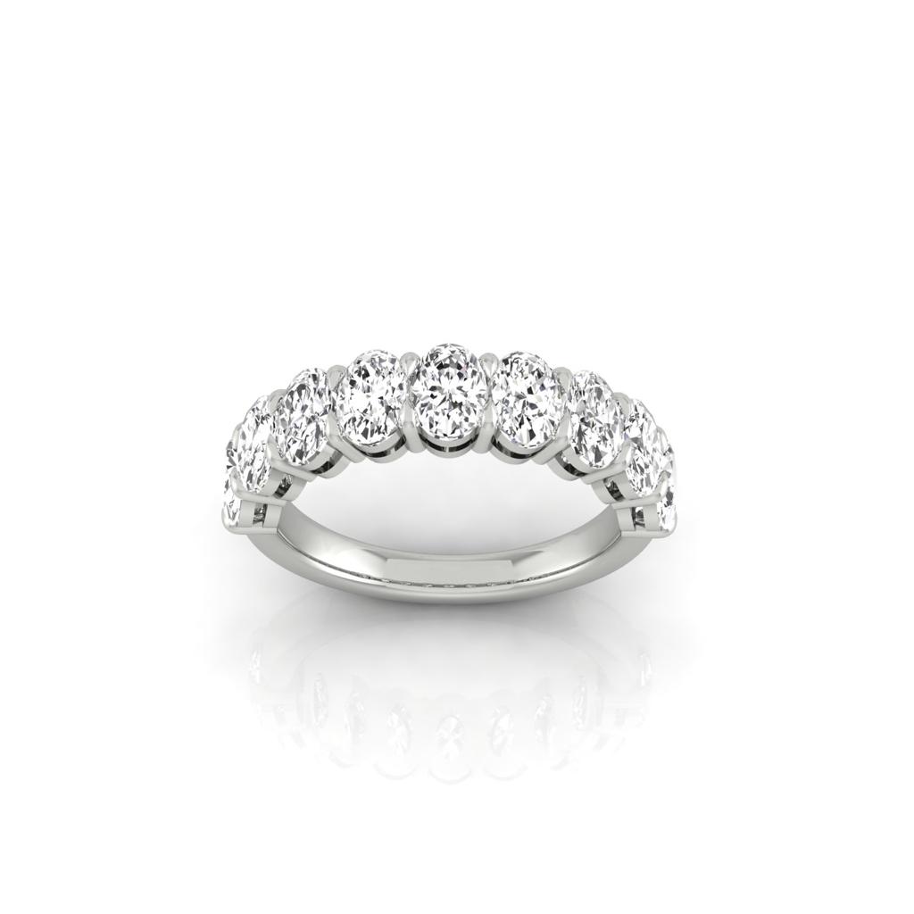 The Half Lab Grown Diamond Eternity Ring from Janet Heller Fine Jewelry, crafted in 18KT gold, features a row of evenly spaced diamonds offered in various shapes and custom carat weights. The color of the diamonds is F and the clarity is VS. This is the perfect wedding band to be worn alone or stacked with your engagement ring.