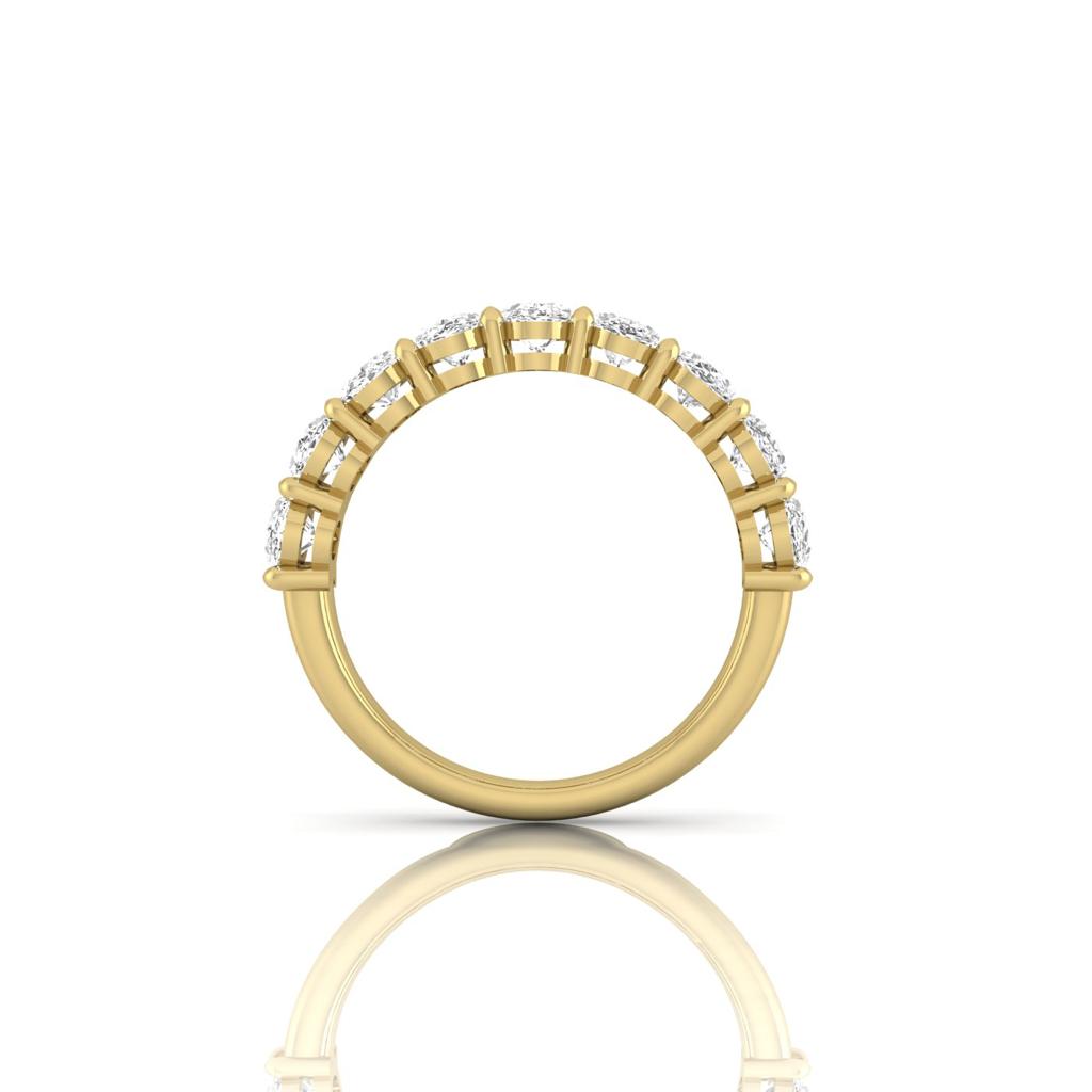 The Half Diamond Eternity Ring, an 18KT gold band, features sparkling VS clarity diamonds on the top half. Set on a plain white background, its reflection is subtly visible below.