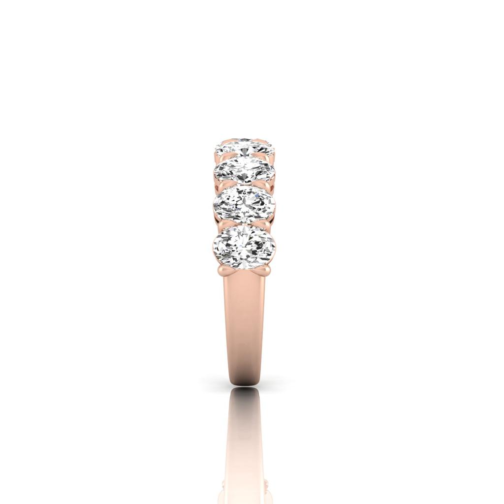 Side view of the Half Diamond Eternity Ring in rose gold, crafted from 18KT gold and featuring five VS Clarity diamonds set along the band, displayed against a white background.