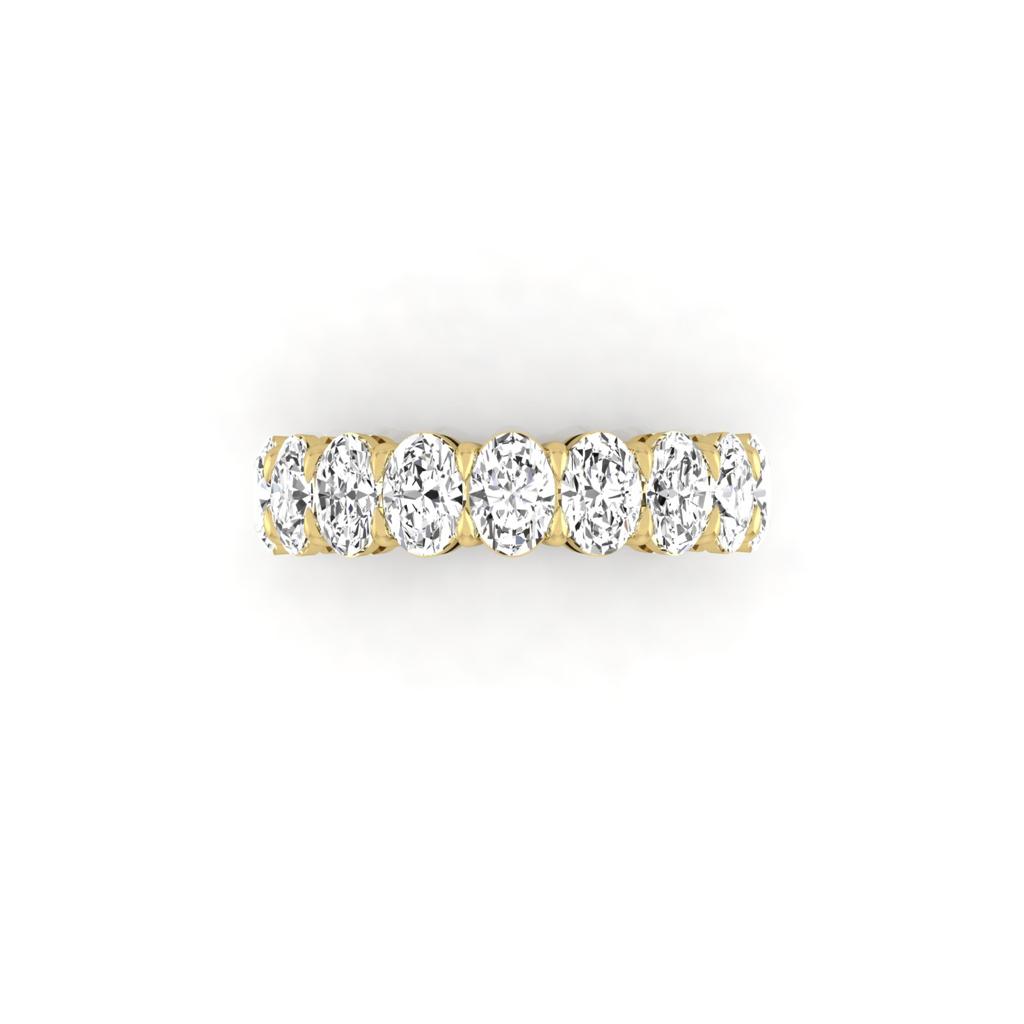 The Half Lab Grown Diamond Eternity Ring from Janet Heller Fine Jewelry, crafted in 18KT gold, features a row of evenly spaced diamonds offered in various shapes and custom carat weights. The color of the diamonds is F and the clarity is VS. This is the perfect wedding band to be worn alone or stacked with your engagement ring.