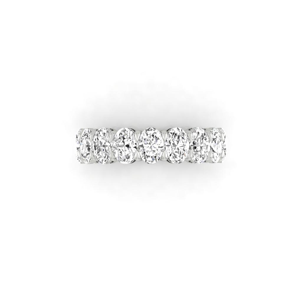 The Half Lab Grown Diamond Eternity Ring from Janet Heller Fine Jewelry, crafted in 18KT gold, features a row of evenly spaced diamonds offered in various shapes and custom carat weights. The color of the diamonds is F and the clarity is VS. This is the perfect wedding band to be worn alone or stacked with your engagement ring.