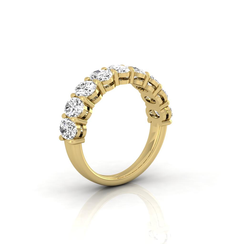 The Half Diamond Eternity Ring, in 18KT gold, features VS clarity round diamonds set along the band, elegantly presented against a plain white background to enhance its luxurious appearance.