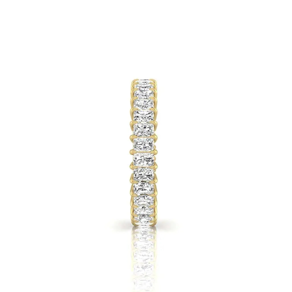 The Full Diamond Eternity Ring is crafted from 18KT gold, featuring a band set with sparkling white diamonds of VS Clarity, beautifully reflecting light on a white background.